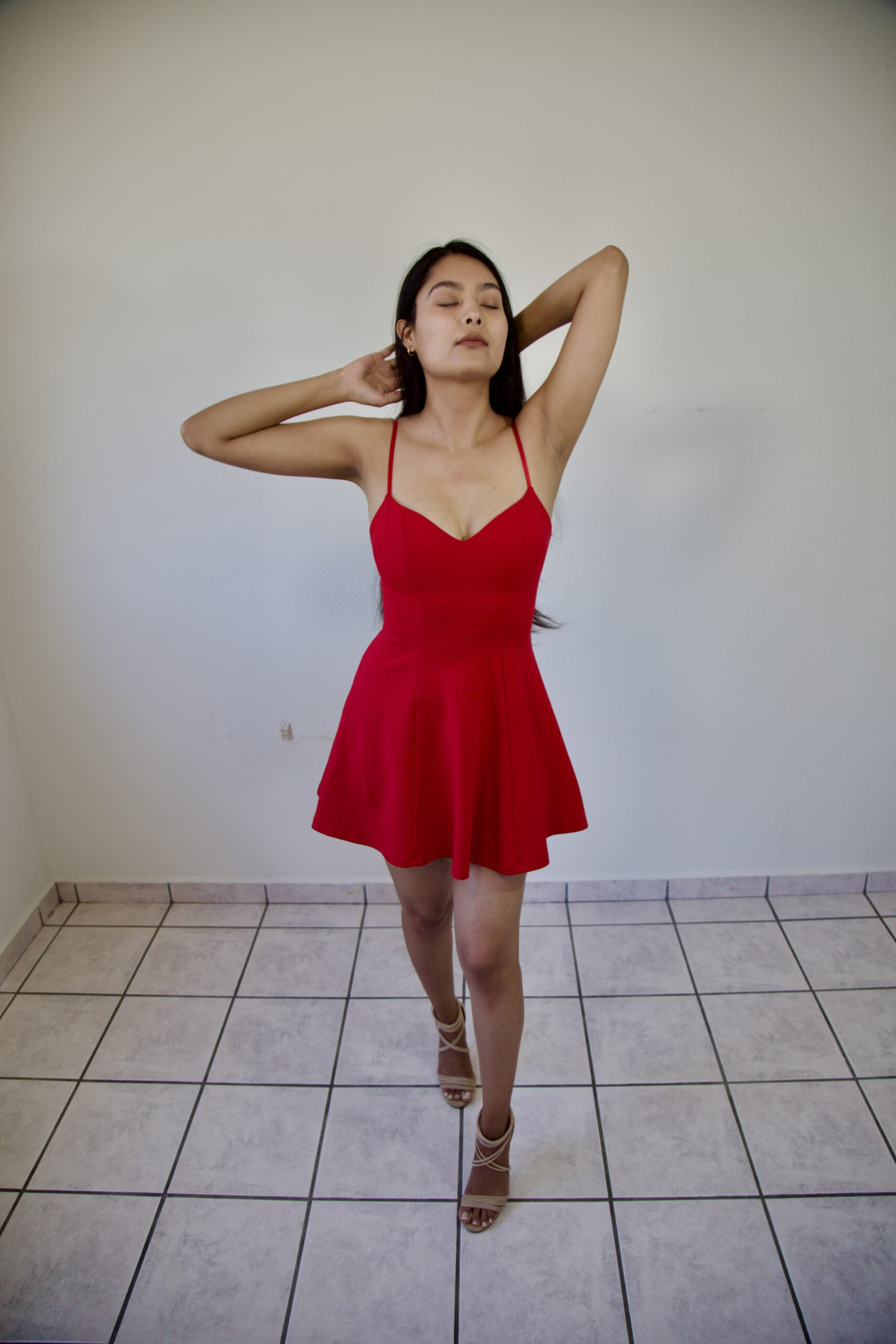 Model Karina Araujo wearing a short red women's dress.
