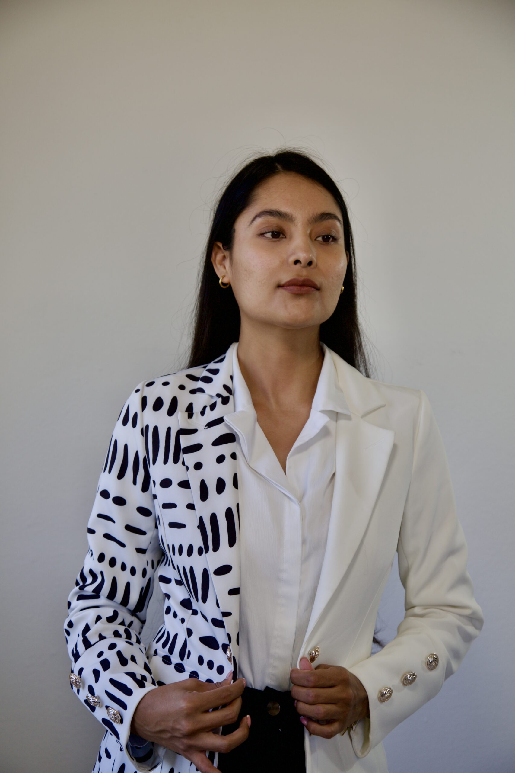 model Karina Araujo in a white and black professional suit for women