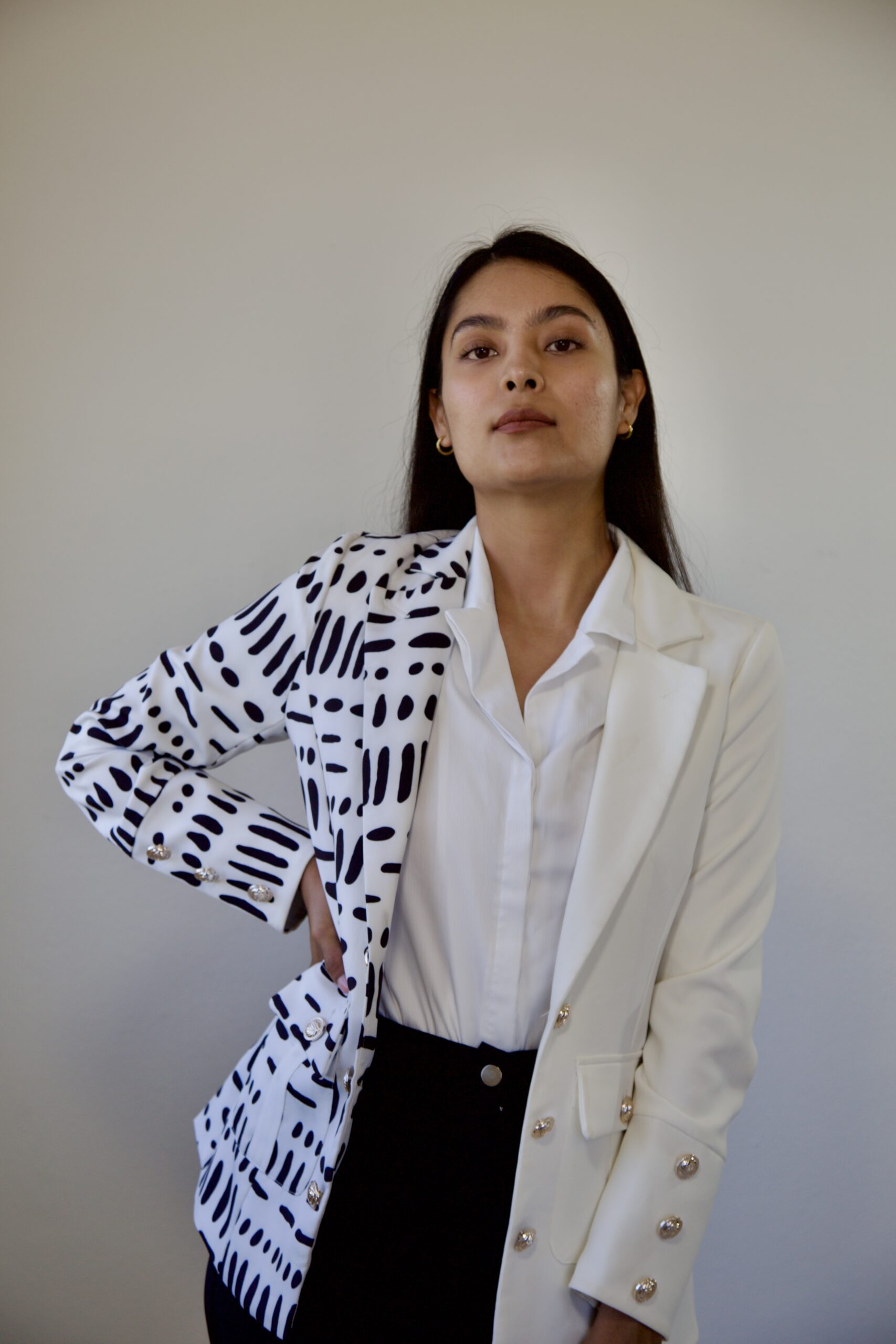 model Karina Araujo in a white and black professional suit for women