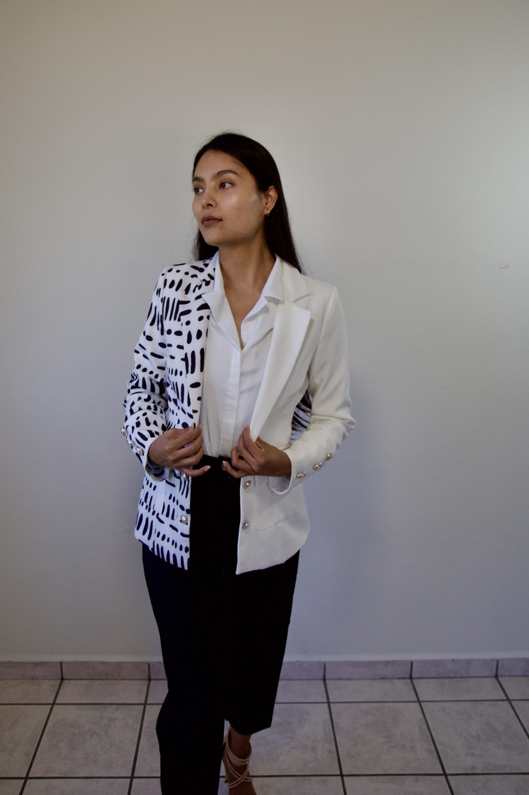 model Karina Araujo in a white and black professional suit for women